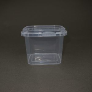 A container with a lid on the ground