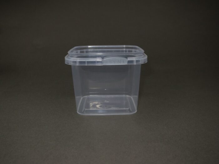 A container with a lid on the ground