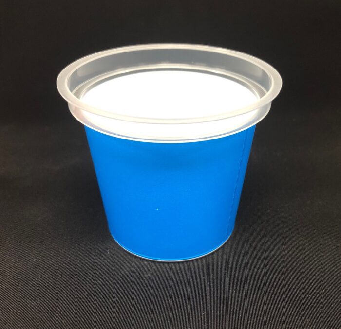 A blue cup with white lid on black surface.