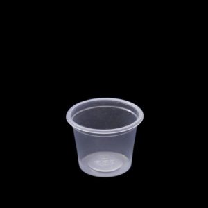 A plastic cup is sitting on the ground.