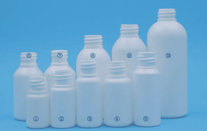 A group of white bottles on top of a blue background.